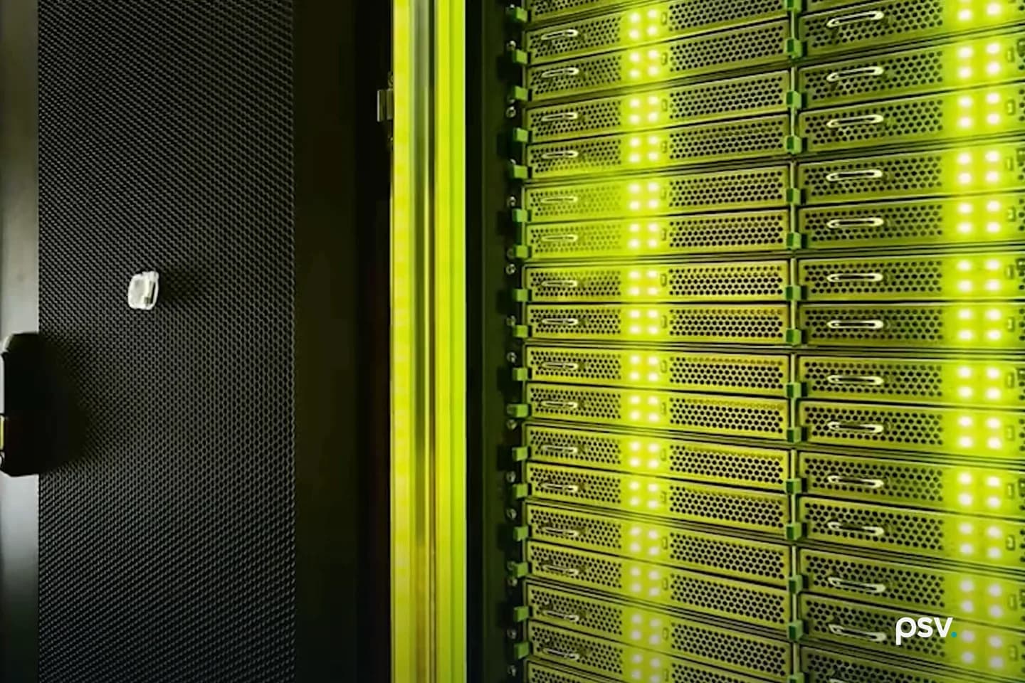 Inside a dim data hall: an open perforated black cabinet door on the left, and to the right a tall rack face packed with rows of server units, their status lights glowing white and green under green aisle lighting Inside a dim data hall: an open perforated black cabinet door on the left, and to the right a tall rack face packed with rows of server units, their status lights glowing white and green under green aisle lighting