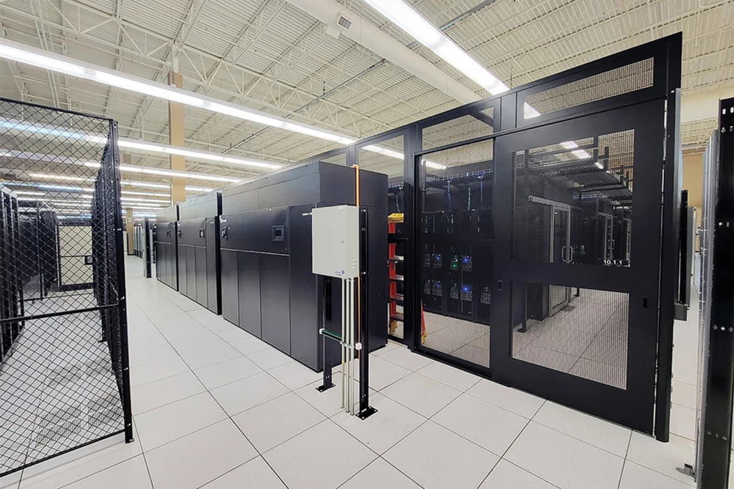 Csquare data center interior with secure cages, server racks, power equipment, and raised floor infrastructure Csquare data center interior with secure cages, server racks, power equipment, and raised floor infrastructure